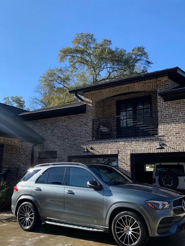 Silver Mercedes-Benz GLE clean outside a brick house