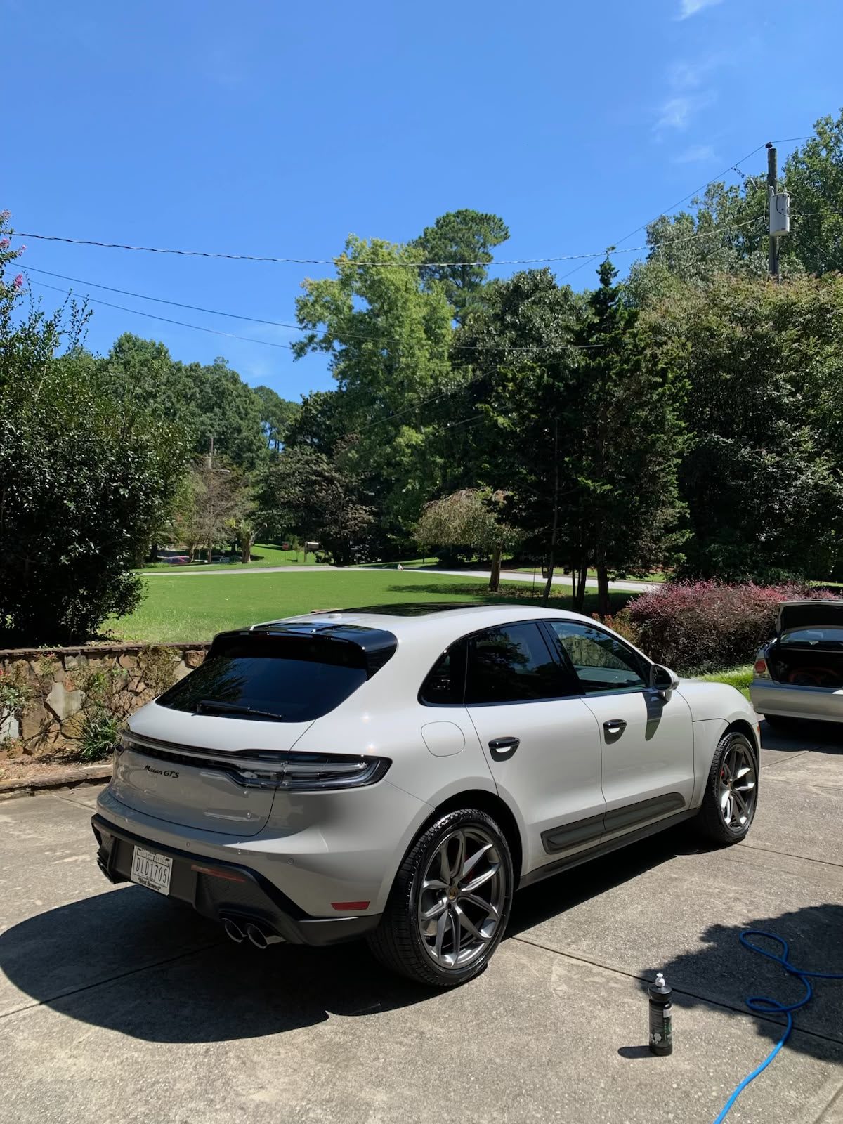 A white Porsche Macan GTS washed and gleaming on a driveway