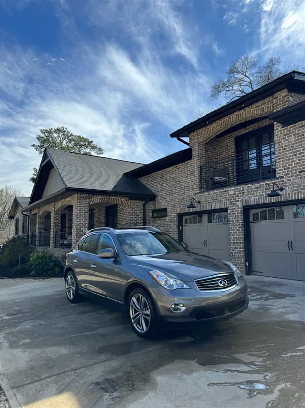 Silver crossover clean and parked outside a house