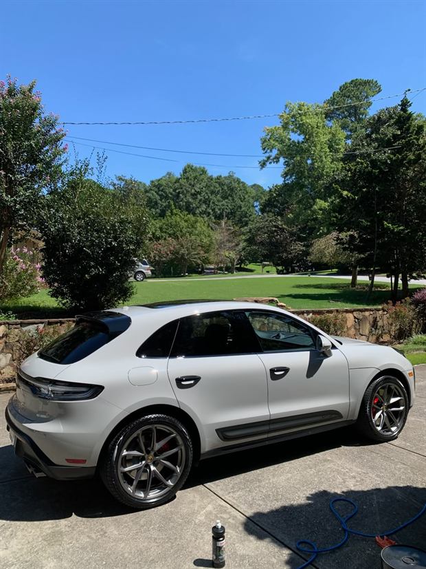 White Porsche Macan washed and drying on a driveway