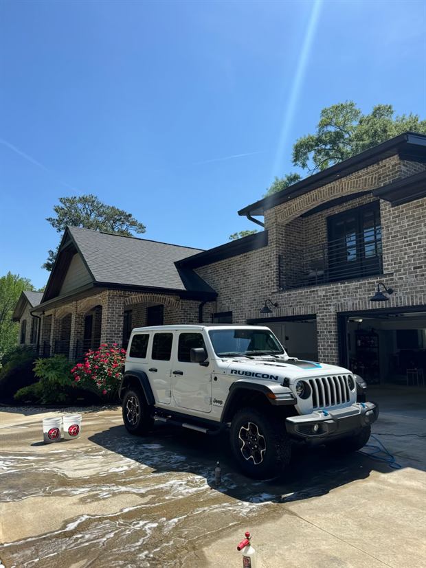 White Jeep Wrangler washed and parked on a driveway